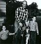 Tod trying despritly to smile with his Dad and Leonard